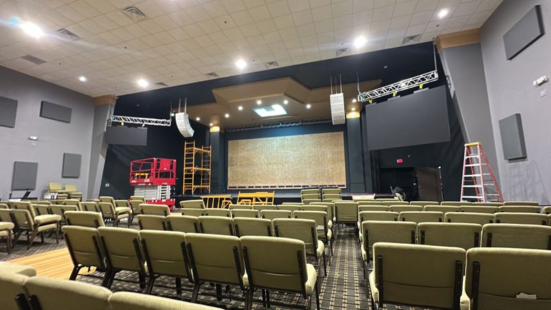 Before: sanctuary stage with a blank backing wall and truss in place