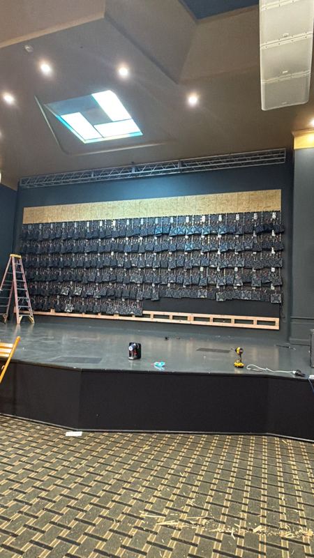 Cabinet rows rising across the wall, cabling dressed behind each column